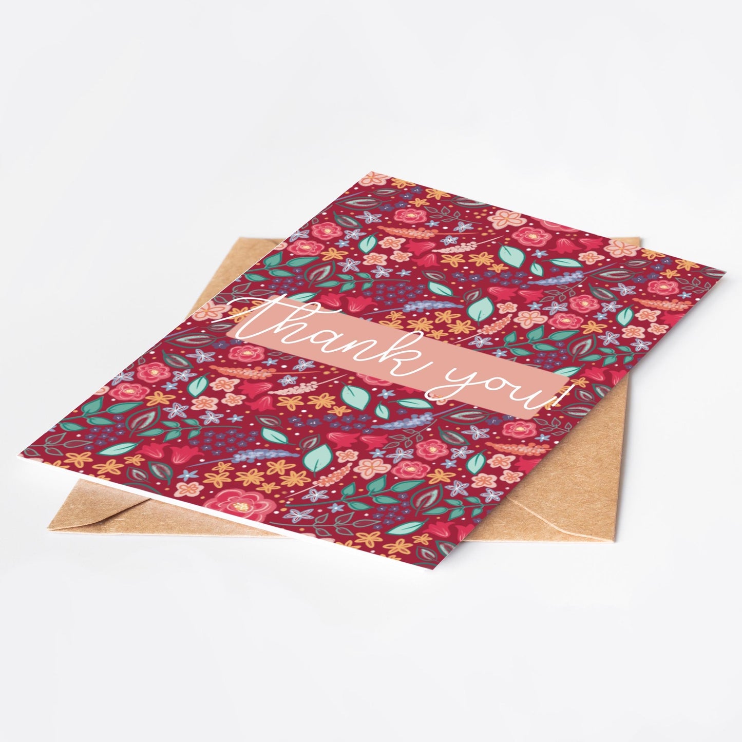 Floral patterned pink card with 'Thank you' text on a white background