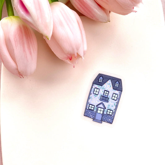Small blue house sticker with floral pattern on a pink tulip background