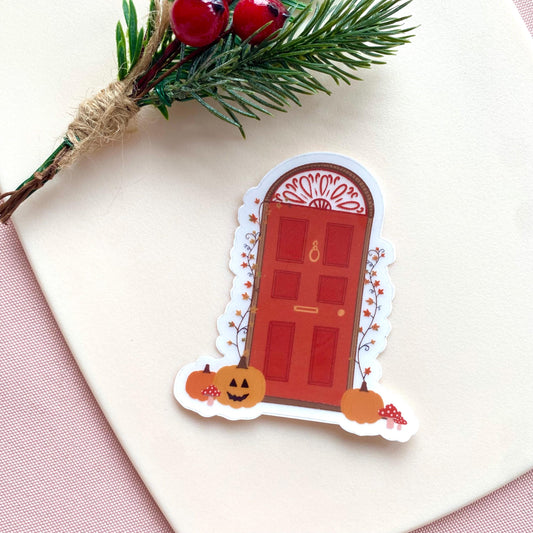 Decorative Halloween door sticker with pumpkins and a red door on a white background