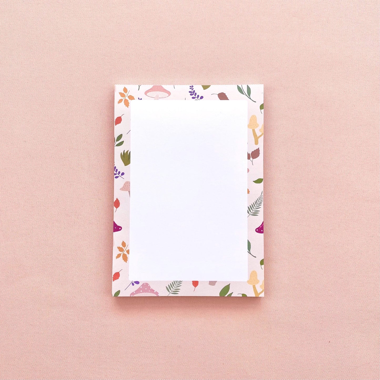 A6 notepad with leaf and mushroom pattern on a pink background