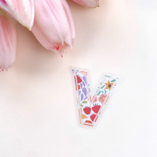 A floral letter 'V' sticker against a white background