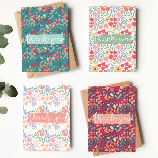 Four floral greeting cards with 'Thank you' text on a white background.
