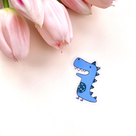 Blue dinosaur sticker on a white background with pink tulips
