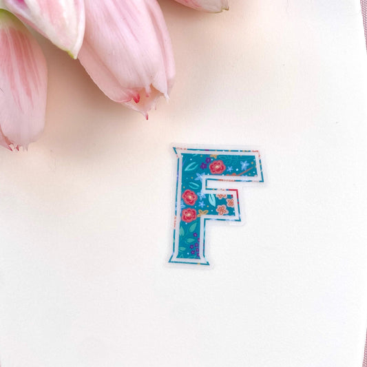 Floral letter 'F' sticker on a white background with pink tulips.