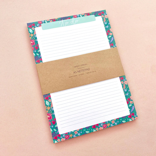 Floral notepad with a brown kraft label on a beige background