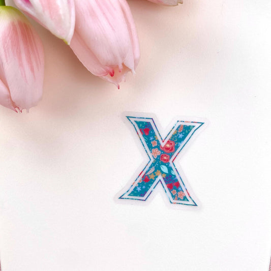 Floral letter 'X' sticker on a light background with pink tulips