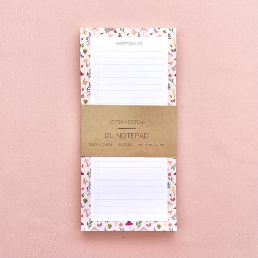 Autumn foliage-patterned shopping list notepad on a pink background