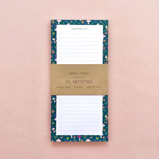 Autumn foliage-patterned shopping list notepad on a pink background