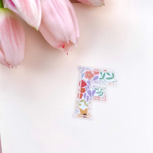 Floral letter 'F' clear sticker against a white background.