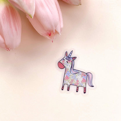Floral unicorn sticker on a light pink background with pink tulips