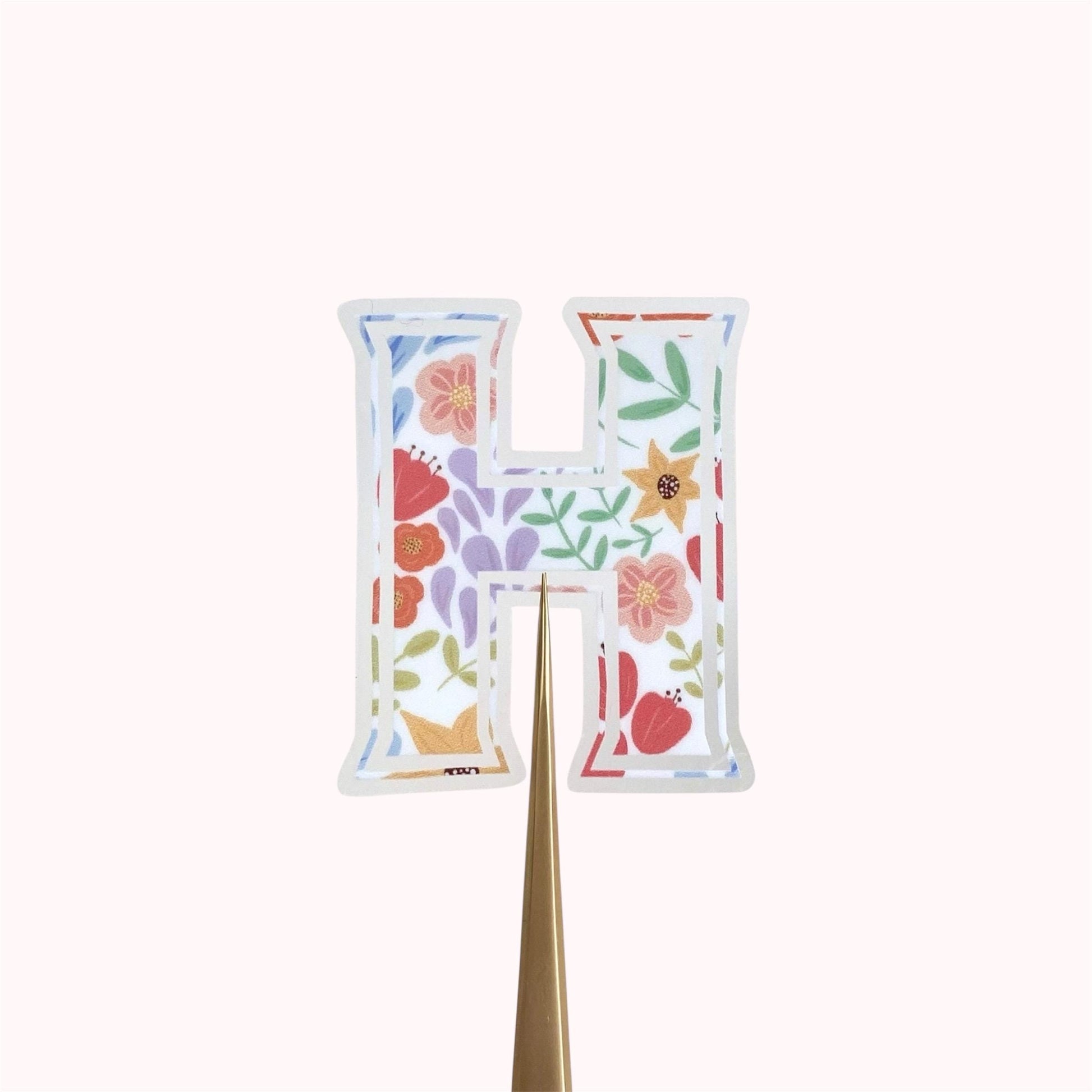 Letter 'H' sticker with floral design on a white background