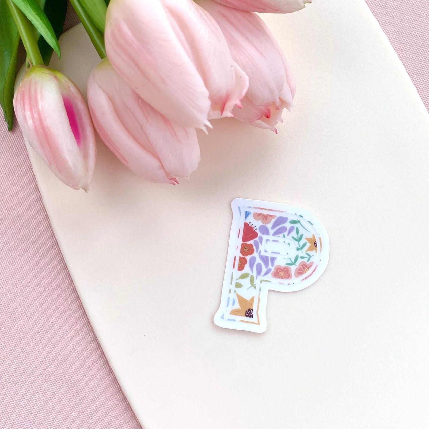 Floral letter 'P' sticker on a cream background with pink tulips.