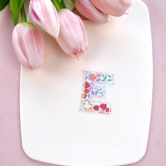 Letter 'E' sticker with floral design on a white background with pink tulips