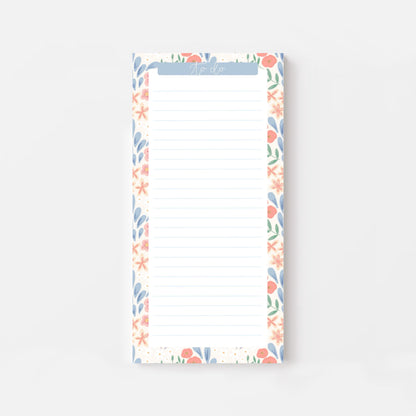 Floral bordered and lined slim notepad on a white background