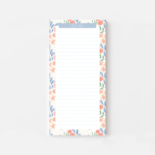 Floral bordered and lined slim notepad on a white background