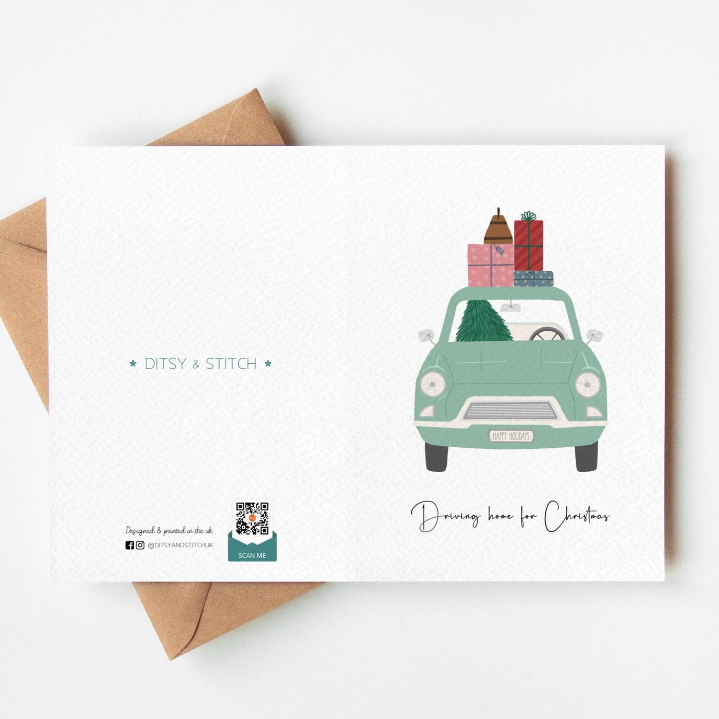 Christmas card with a green car carrying presents, envelope on a white background