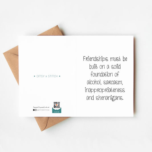 Card with humorous text about friendships and an envelope on a white background