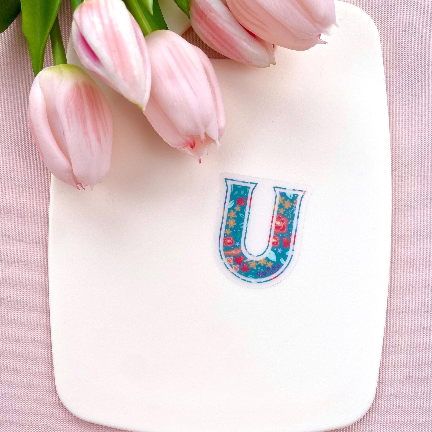Decorative letter 'U' sticker with floral pattern on a white background