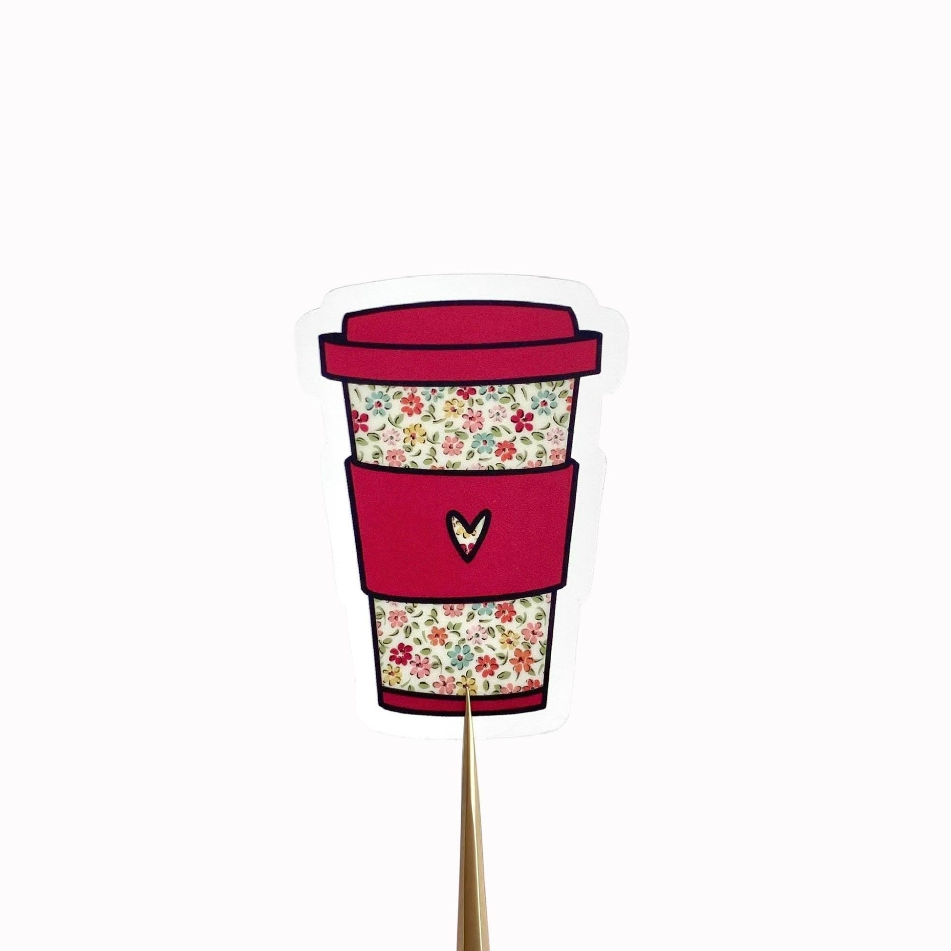 Sticker with an illustration of a floral coffee cup with a dark pink sleeve with a heart on a white background