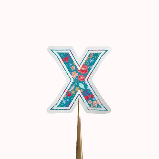 Floral letter 'X' sticker on a light background