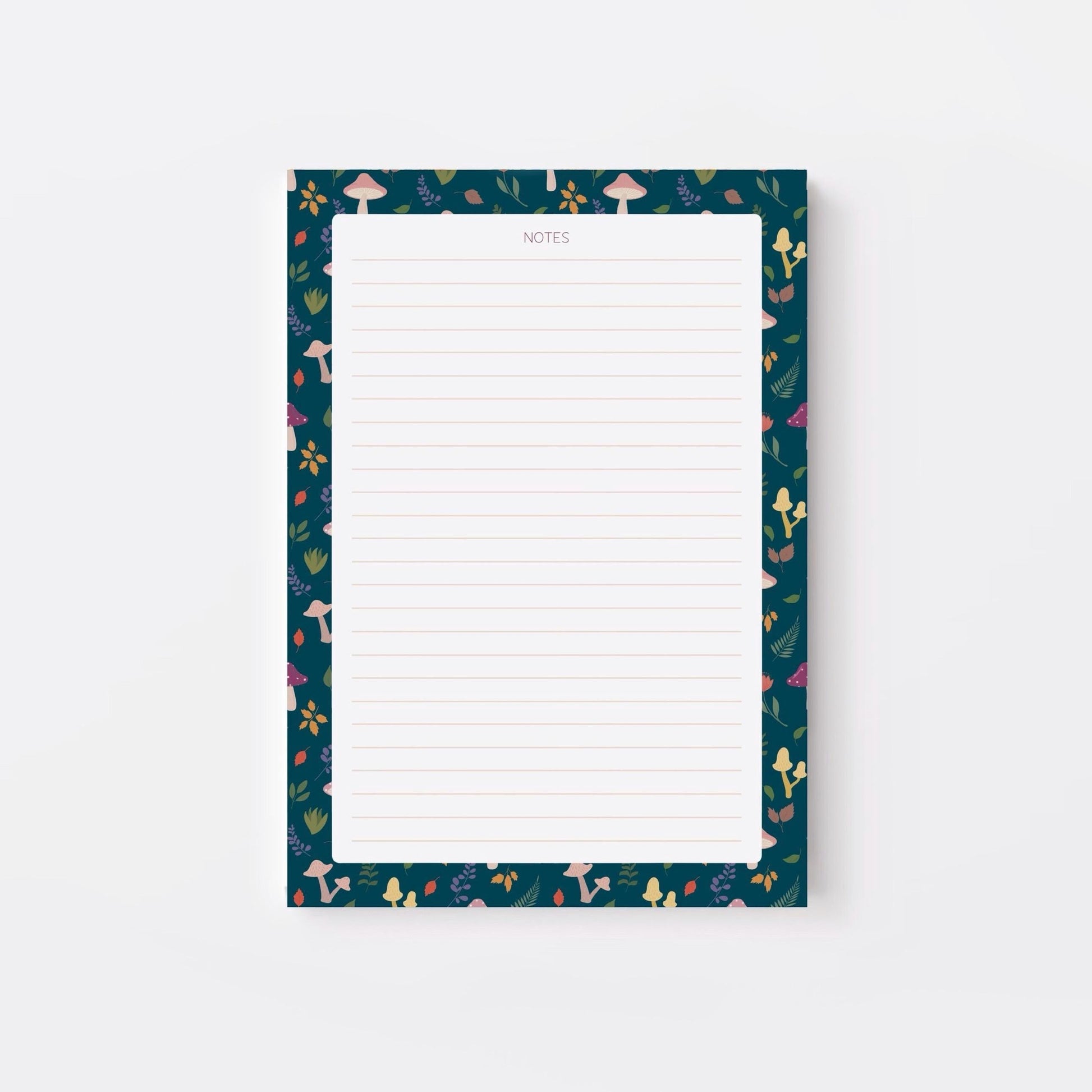 Lined notepad with a decorative blue border featuring mushrooms and leaves on a white background