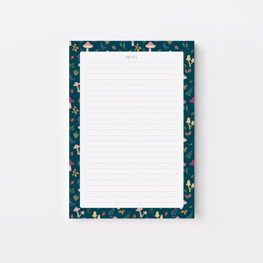 Lined notepad with a decorative blue border featuring mushrooms and leaves on a white background