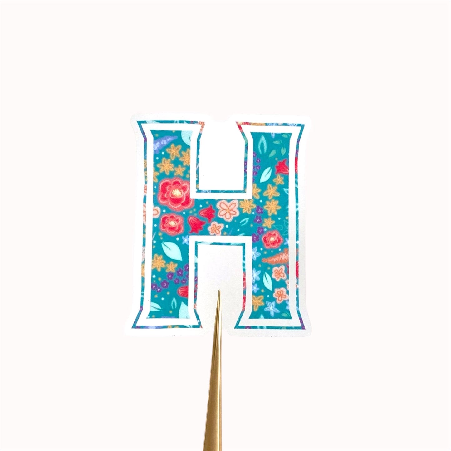 Letter 'H' shaped sticker with floral design on a white background