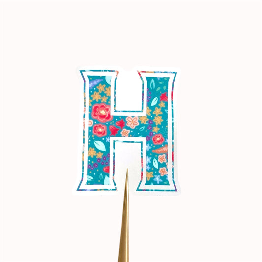 Letter 'H' shaped sticker with floral design on a white background