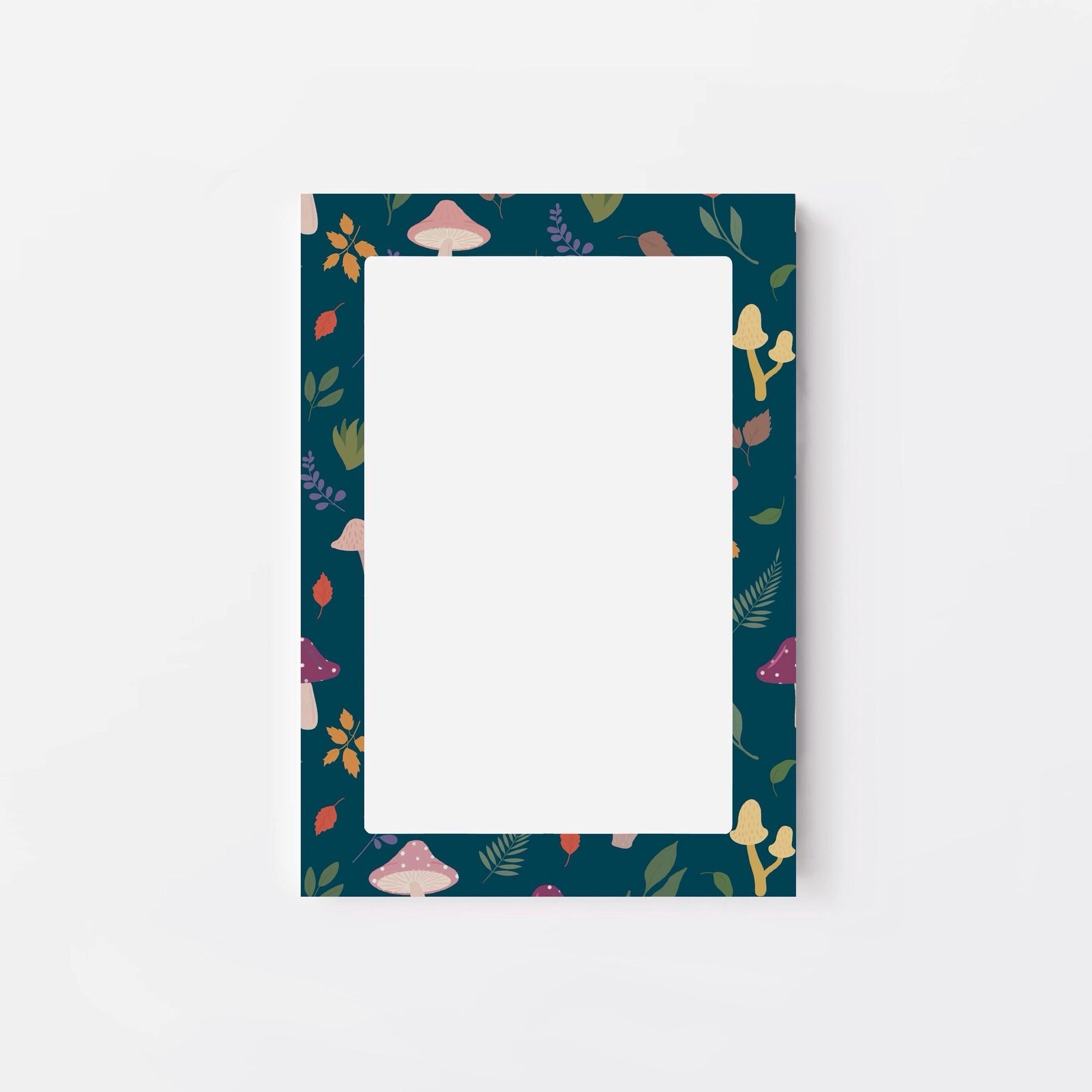 Notepad with mushroom and leaf patterned border on a white background