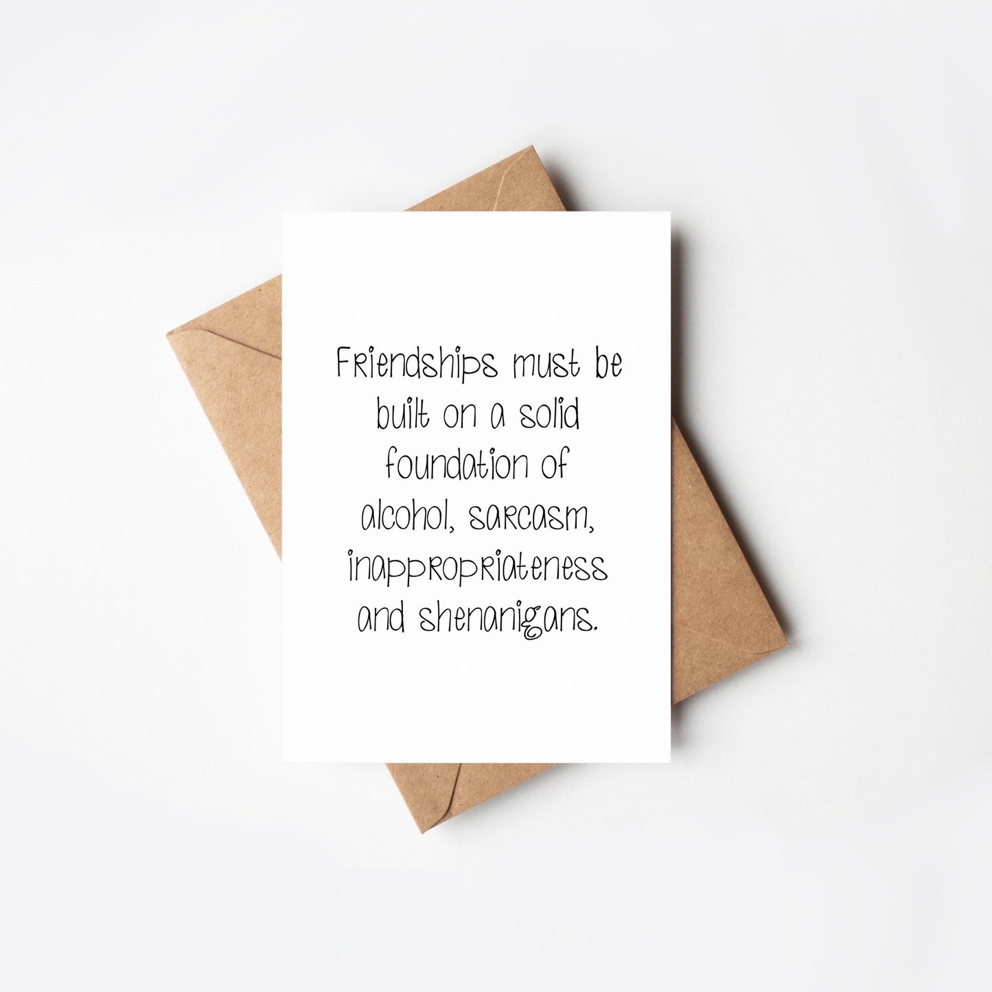 Card with humorous friendship quote on a white background
