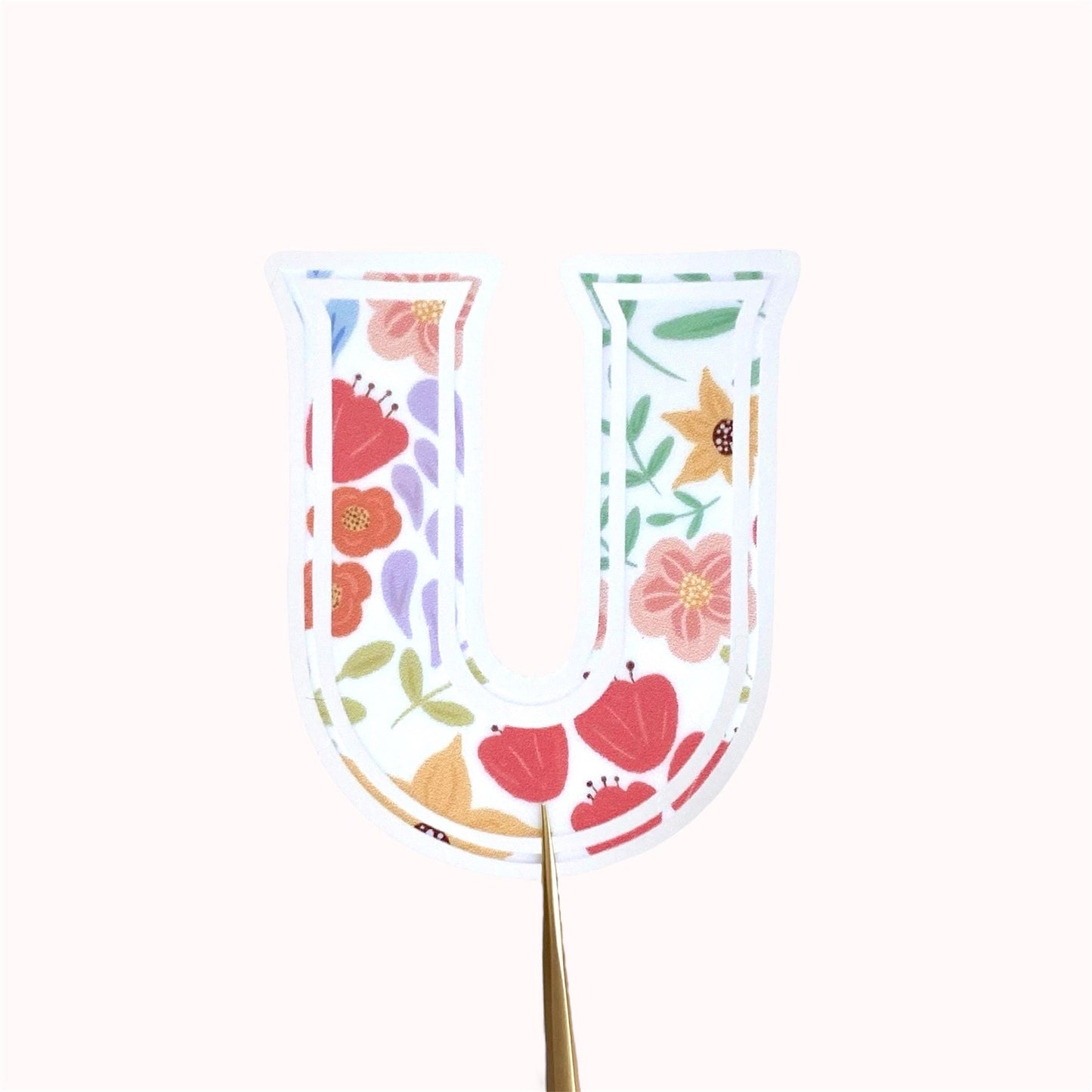 Decorative letter 'U' sticker with floral pattern on a white background