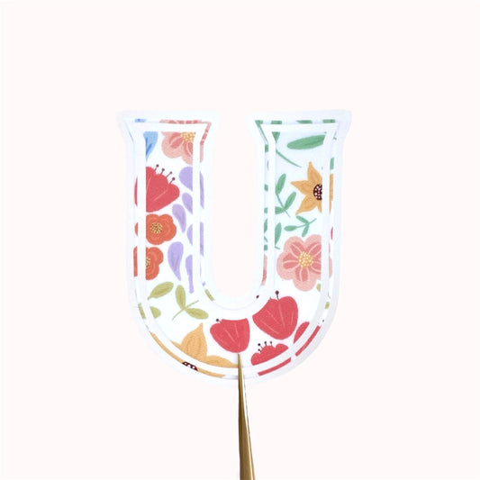 Decorative letter 'U' sticker with floral pattern on a white background