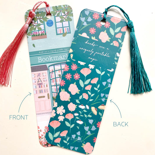 Two colourful bookmarks with tassels held by a hand against a white background, one showing the front and the other showing the back