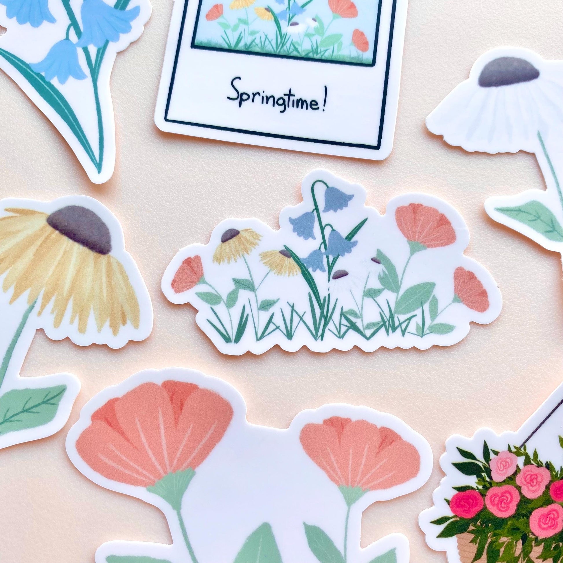 Floral stickers on a beige background with 'Springtime!' polaroid sticker.