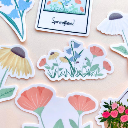 Floral stickers on a beige background with 'Springtime!' polaroid sticker.