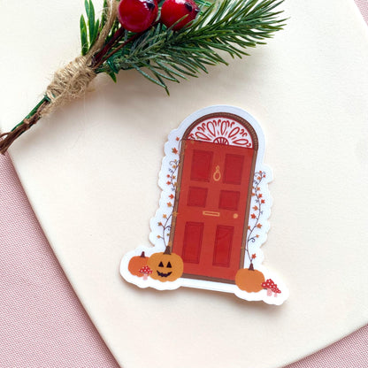 Decorative Halloween door sticker with pumpkins and a red door on a white background
