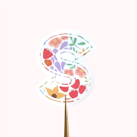 Decorative letter 'S' sticker with floral pattern on a white background