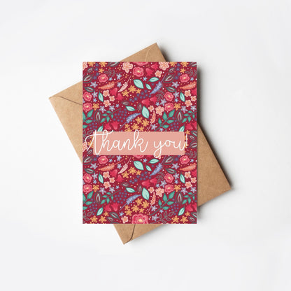 Floral patterned pink card with 'thank you' text on a white background