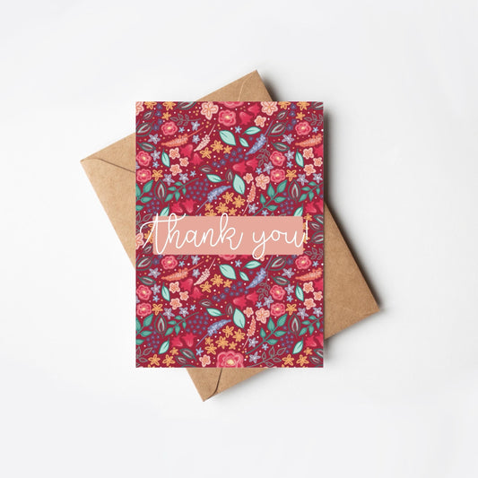 Floral patterned pink card with 'thank you' text on a white background