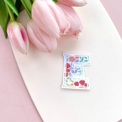 Letter 'E' sticker with floral design on a white background with pink tulips