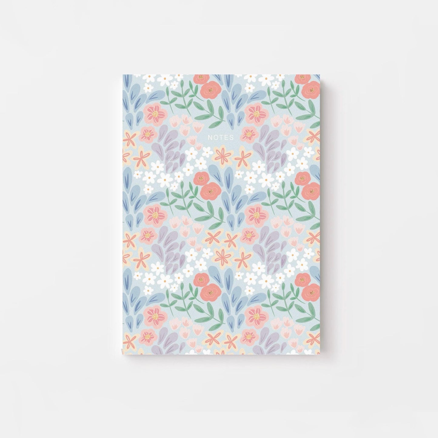 Floral patterned notebook on a light gray background