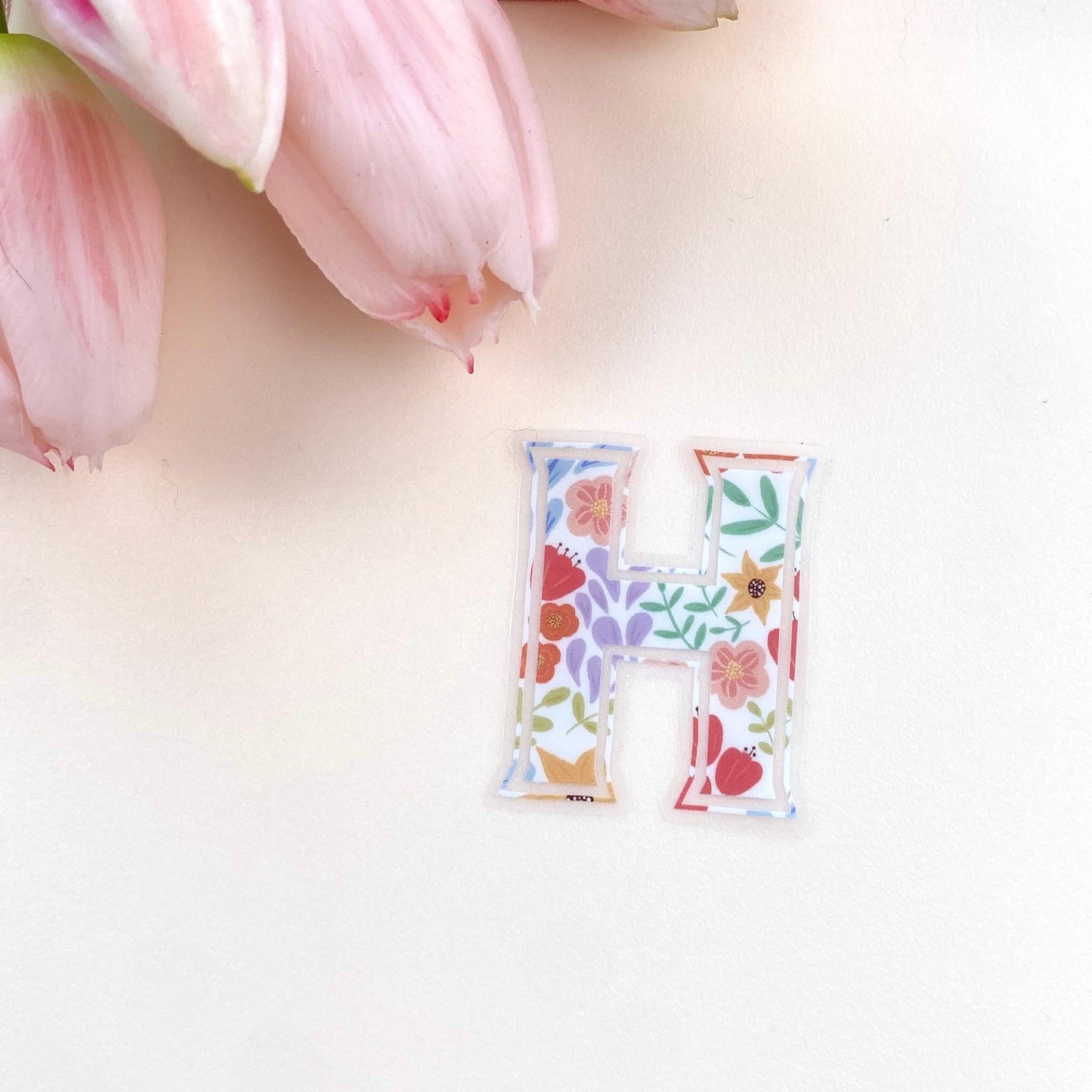 Letter 'H' sticker with floral design on a white background