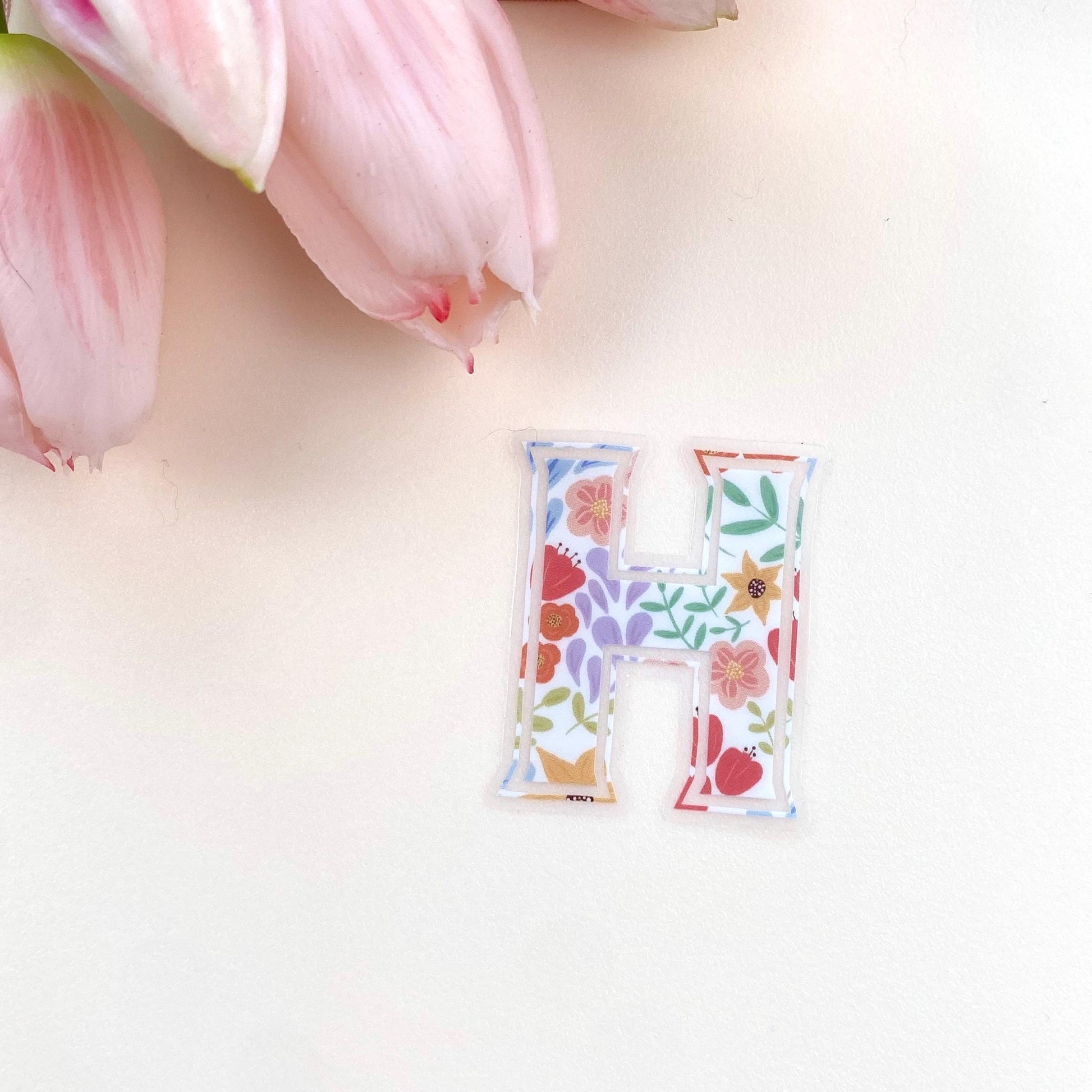 Letter 'H' sticker with floral design on a white background