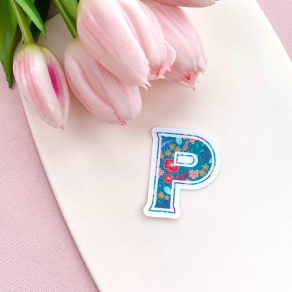 Decorative letter 'P' sticker with floral pattern on a white background with pink tulips