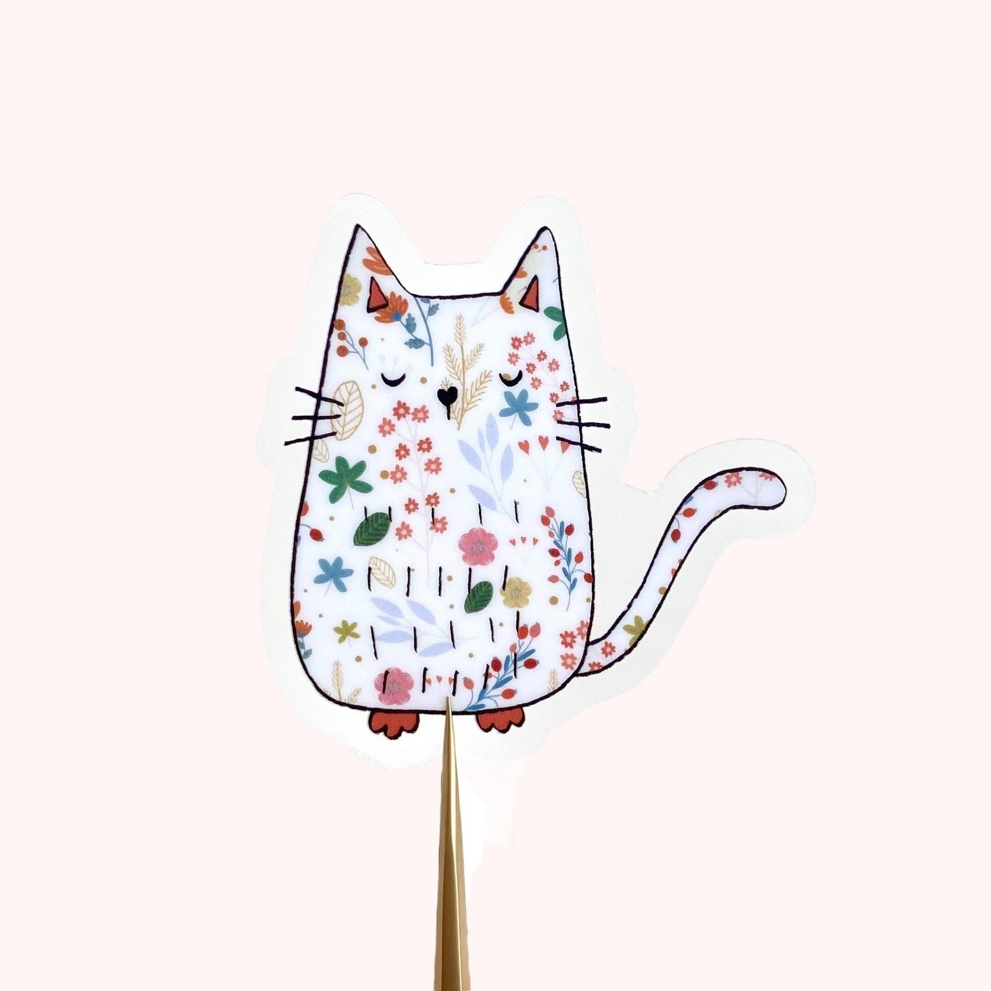 Decorative cat-shaped sticker with floral pattern on a white background
