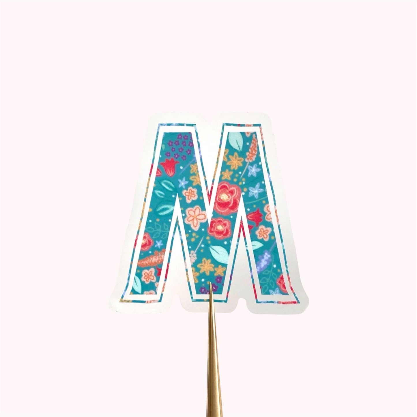 Colourful letter 'M' sticker on a white background