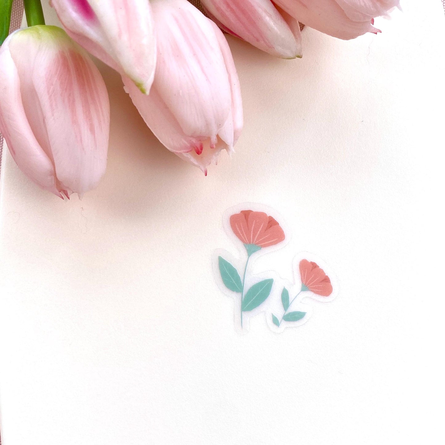 Pink flowers sticker against a cream background.
