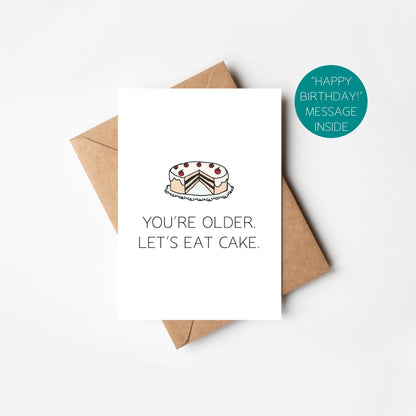 Greeting card with cake illustration and text 'You're older. Let's eat cake.' on a white background.