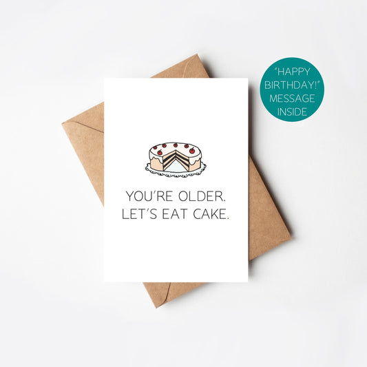 Greeting card with cake illustration and text 'You're older. Let's eat cake.' on a white background.