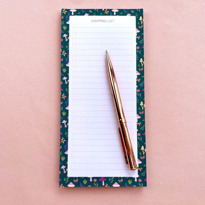 Autumn foliage-patterned shopping list notepad on a pink background